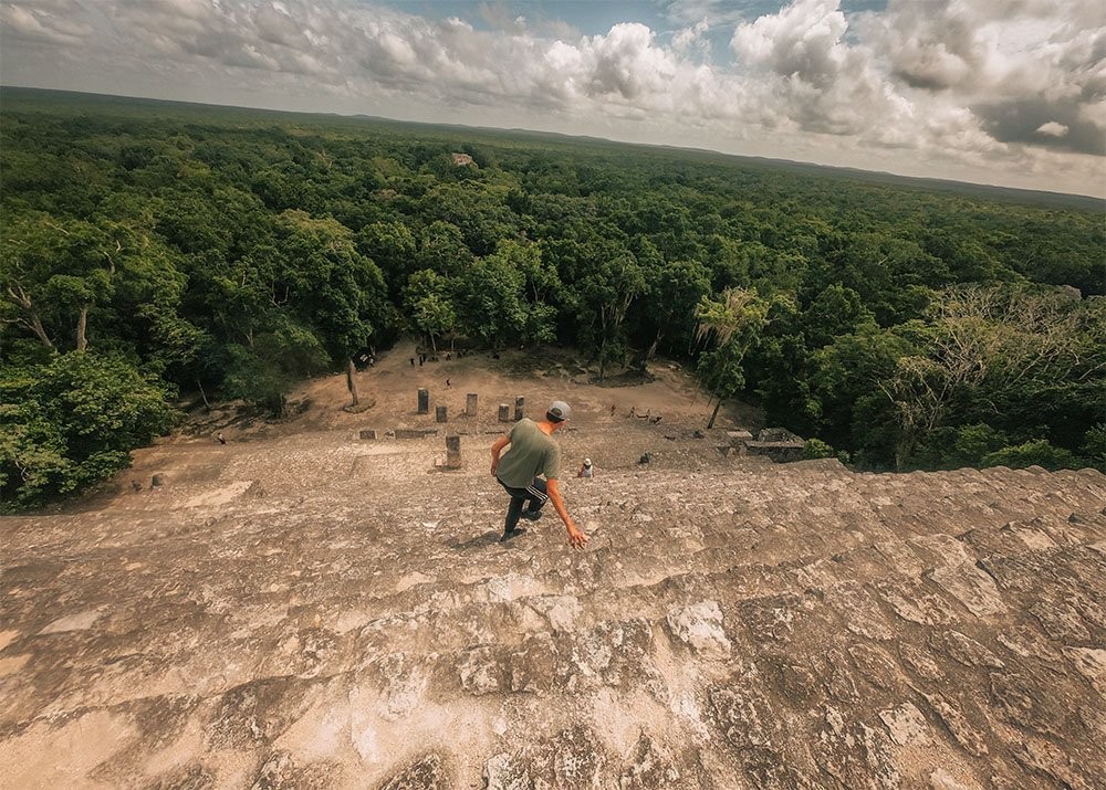 Climbing down the Acropolis Chik Naab at the Calakmul ruins in Mexico