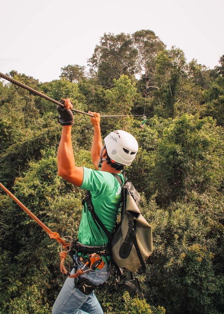A man waiting for his moment to start ziplining through the jungle at Xplor in Playa Del Carmen in Mexico