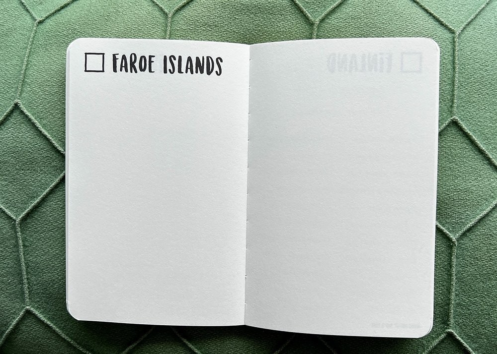 A blank page in a travel journal only filled with the pre printed words Faroe Islands and a checkbox in front of it.